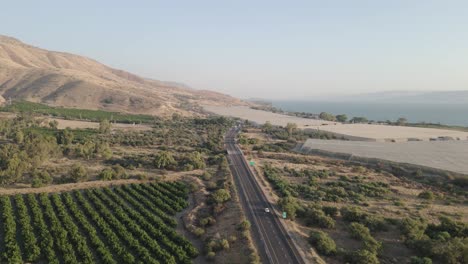 Aerial-view-of-big-greenhouses-along-sea-of-galilee,-open-landscape