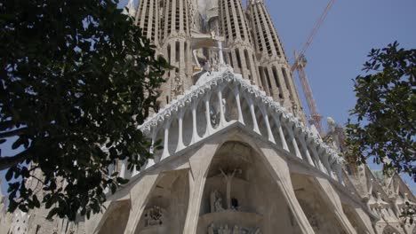 Sky-to-Mid-Street-View,-The-Famous-Sagrada-Familia-Cathedral-in-Barcelona-Spain-in-the-Early-Morning-in-6K