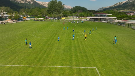 Team-Of-Players-Playing-Football-In-Outdoor-Field-In-Baska,-Krk,-Croatia
