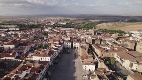 Touristic-city-square-in-Caceres,-drone-dolly-backward-on-a-sunny-summer-morning