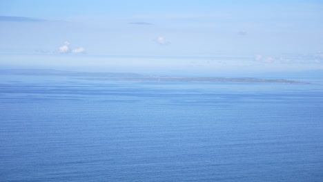 Aran-Islands-seen-from-Cliffs-of-Moher-in-Ireland,-clear-sky,-peaceful-day
