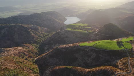 Aerial-sunset-of-rolling-hills-to-reveal-a-lake-in-the-Napa-Valley