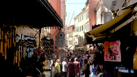 People-Walking-in-Kerkyra-Corfu-Greece-Alley-with-Shops-in-a-Sunny-Summer-Day,-Real-time-Footage