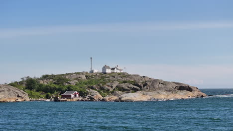 Stavernsodden-Lighthouse-Atop-The-Rocky-Coastal-Seen-From-Distance-In-Larvik,-Norway