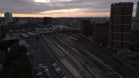 Pullback-Establishing-Drone-Shot-of-Leeds-City-Centre-and-Train-Station-with-LNER-Train-Departing