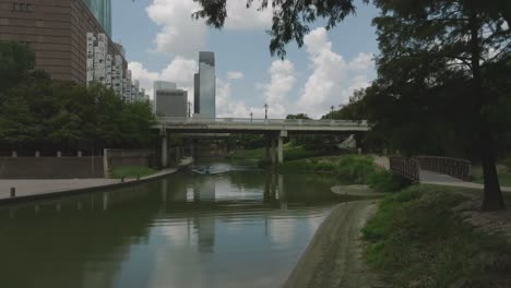 Aerial-drone-view-of-kayakers-with-kayak-instructor-paddling-down-Buffalo-Bayou-in-downtown-Houston-Texas
