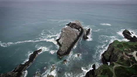 Aerial-shot-by-drone-of-Bow-fiddle-rock-at-Portknockie-during-cloudy-day