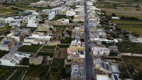 Aerial-drone-view-of-town-in-Malta-with-cars-parked-in-the-street-below