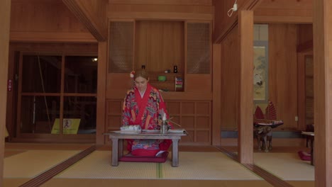 Latin-beautiful-woman-sitting-at-japanese-traditional-house-at-okinawa-world-Naha-Japan-wearing-ryusou-dress-kimono-tilt-shot