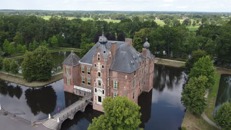 Cannenburch-Castle,-The-Netherlands:-aerial-view-up-to-the-beautiful-castle-and-where-you-can-see-the-moat-that-surrounds-it