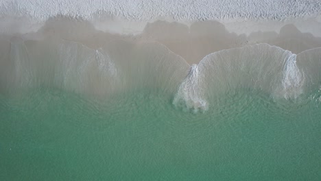 Aerial-view-of-clear-emerald-waters-of-Gulf-of-Mexico-Florida's-white-sand-beach-on-a-bright-sunny-day-on-the-Gulf-of-Mexico