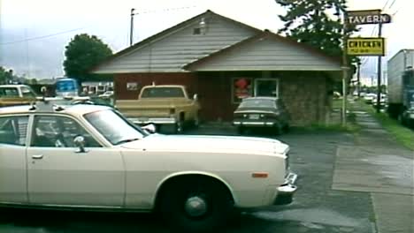 1980S-COP-CAR-PARKED-OUTSIDE-RESTAURANT-BAR-IN-DAYTIME