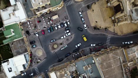 Cinematic-top-down-aerial-turning-overhead-of-town-square-in-Malta