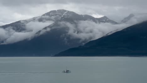A-fishing-boat-in-a-fjord-along-the-Alaskan-coast-as-seen-from-a-cruise-ship