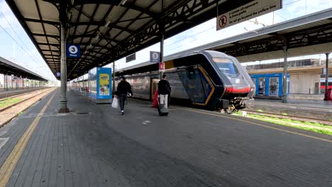 Passengers-Rushing-To-Board-Train-At-Bologna-Centrale-As-It-Departs-Platform,-Missing-Train