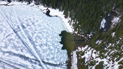 Aerial-birdseye-circling-over-frozen-Lower-Joffre-Lake,-Canada