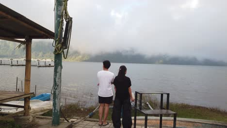 Romantic-Young-Couple-Staring-at-Beratan-Cloudy-Lake-in-Bedugul-Bali-Indonesia