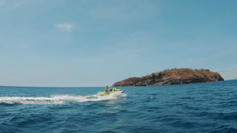Cinematic-slow-motion-shot-of-a-waverunner-going-through-waves-in-the-bright-blue-ocean-on-a-sunny-day-in-the-Philippines,-Asia,-Jet-Ski,-Slomo