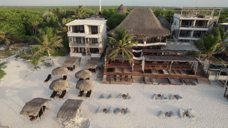 Aerial-view-of-luxury-resort-on-white-sand-beach-in-Tulum,-Mexico