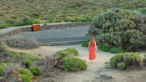 Attractive-woman-walking-out-of-Teide-national-park,-back-view