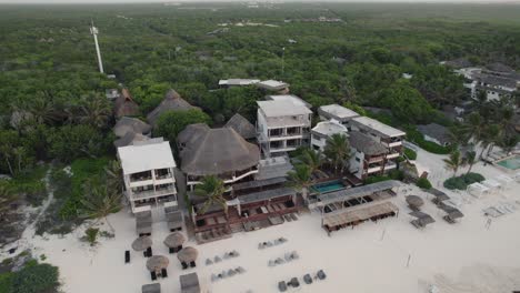 Wide-aerial-view-of-luxury-tropical-resort-on-the-beach-in-Tulum,-Mexico