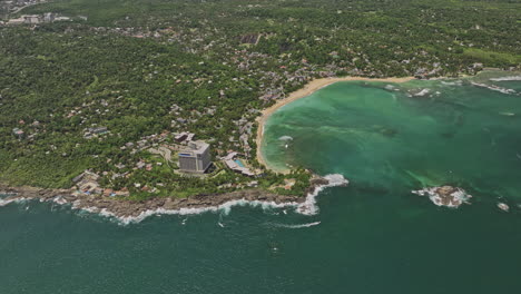 Unawatuna-Sri-Lanka-Aerial-v3-high-altitude-birds-eye-view-flyover-bay-capturing-Goda-Gala-Reef-and-rocky-shoreline-of-Yaddehimulla,-resort-hotels-along-the-beach---Shot-with-Mavic-3-Cine---April-2023