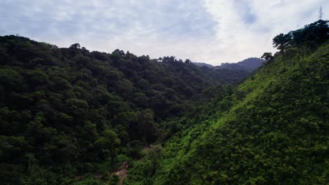 Lush-green-valley-with-steep-hillsides-and-flowing-river-below