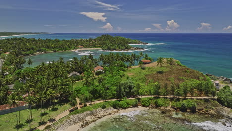Koattagoda-Sri-Lanka-Aerial-v3-fly-along-Talalla-beach-towards-Seethagalla-beach-capturing-hillside-sea-views-resort-hotels-and-swelling-waves-and-lush-palms---Shot-with-Mavic-3-Cine---April-2023