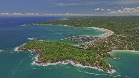 Kudawella-Sri-Lanka-Aerial-v5-cinematic-high-altitude-pull-out-shot-capturing-Hummanaya-blow-hole,-sandy-beach,-fishing-harbor-and-beautiful-Indian-oceanscape---Shot-with-Mavic-3-Cine---April-2023