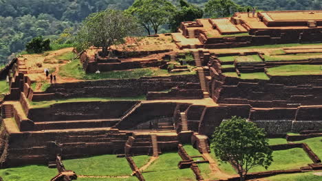 Sigiriya-Sri-Lanka-Aerial-v9-close-up-view,-drone-fly-around-Sigiriya-rock-ruins,-an-old-ancient-fortress-and-royal-residence-atop-of-massive-granite-rock---Shot-with-Mavic-3-Cine---April-2023
