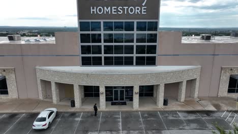 A-4K-Rising-Person-Walking-Cinematic-Drone-Shot-of-an-Ashley-Furniture-HomeStore-Global-Industry-Retail-Shopping-Décor-Accessory-Store-Located-in-Chicago-Illinois