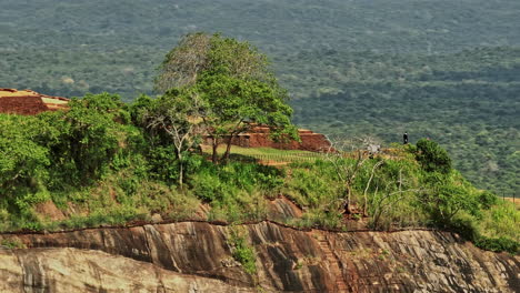 Sigiriya-Sri-Lanka-Aerial-v8-cinematic-close-up,-drone-fly-around-hilltop-Sigiriya-Rock-capturing-spectacular-ruins-of-ancient-fort-and-remains-of-royal-residence---Shot-with-Mavic-3-Cine---April-2023