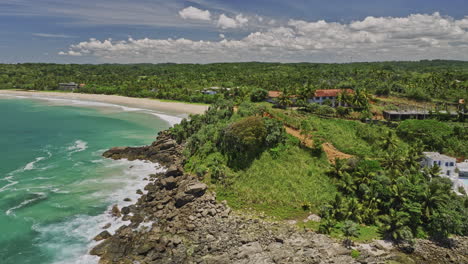 Koattagoda-Sri-Lanka-Aerial-v2-fly-around-hillside-Talalla-hillside-resort-hotels-capturing-Seethagalla-beach-with-pristine-sea-water-on-a-beautiful-sunny-day---Shot-with-Mavic-3-Cine---April-2023