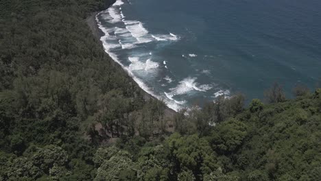 Aerial-descends-to-Pololu-Valley-pebble-beach-on-Hawaii-shoreline