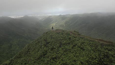 Flyover:-Man-on-high-Moanalua-mountain-ridge-overlooks-Honolulu-below