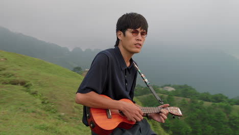 Junger-Asiatischer-Musiker,-Der-Ukulele-Spielt
