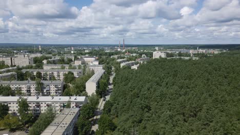 Dolly-left-aerial-from-forest-to-Soviet-residential-area-in-former-USSR