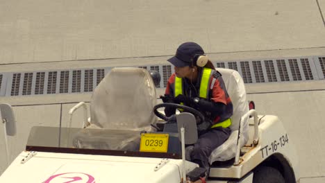 Japanese-Woman-female-staff-Narita-International-Airport-Okinawa-crew-truck-driver-at-landing-track-talking-by-radio-walkie-talkie-instruction-control-tower-Japan-airlines