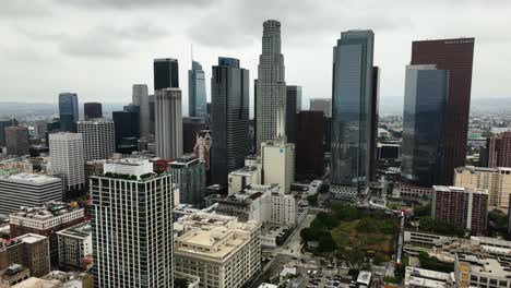 Aerial-view-rising-through-the-skyline-of-downtown-Los-Angeles,-in-cloudy-USA