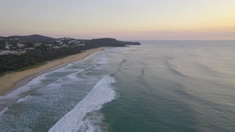 Foamy-Waves-Splashing-Sandy-Shore-Of-Sunshine-Beach-At-Sunset-In-Queensland,-Australia---aerial-shot