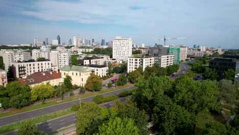 Aerial-tilt-down-shot-showing-cars-on-Highway-in-Suburb-area-of-Warsaw-and-Downtown-Skyline-in-background