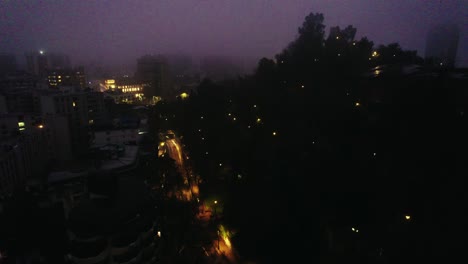 Night-aerial-view-of-Santiago-de-Chile,-foggy-morning,-illuminated-and-lonely-streets
