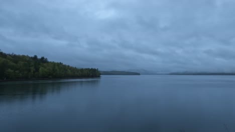 Stunning-walking-hyper-lapse-of-a-dark,-atmospheric-foggy-rainy-lake-in-the-Appalachian-mountains