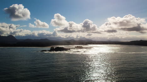 Scenic-seascape-view-of-Tofino-coastline-with-puffy-clouds-in-sky,-aerial
