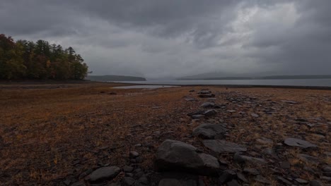 Magical-autumn-time-lapse-of-a-pristine-mountain-lake-on-a-rainy,-stormy-day