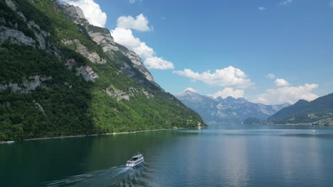 Drone-captures-stunning-Switzerland-tourism-cruise-boat-ride-surrounded-by-breathtaking-natural-beauty