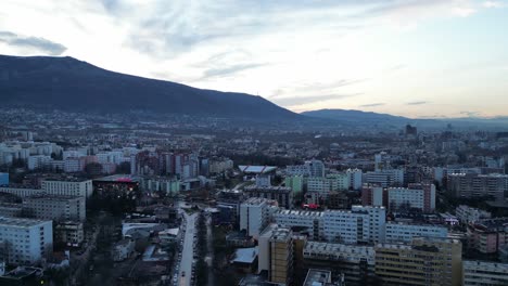 Panoramic-Sofia-Bulgaria-skyline-buildings-and-cityscape-at-sunset,-Drone-shot