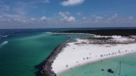 Reveal-Aerial-drone-shot-of-Shell-island-jetties-lagoon-on-Florida’s-Emerald-Coast