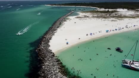 Reveal-aerial-shot-of-white-sands,-and-green-waters-at-Shell-Island-on-Florida’s-Emerald-Coast