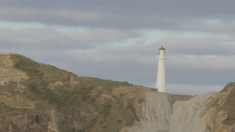 Close-up-of-New-Zealand's-rock-formation-and-lighthouse-at-Castle-Point